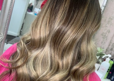 Lush, golden wavy hair styled at Hair by Emma, Motherwell, Scotland, GB, showcasing professional finish.
