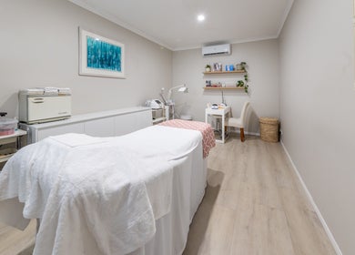 Cozy treatment room at Justine's Accent on Beauty in Mudgeeraba, Queensland, AU, featuring a massage table.