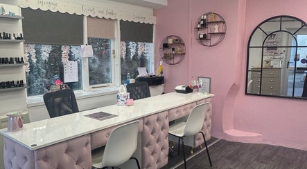 Elegant nail salon interior at Chlos Beauty Corner, Callington, England, GB, featuring pink decor and modern design.