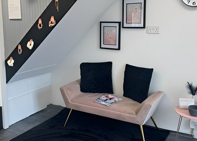 Elegant seating area at Chlos Beauty Corner, Callington, England, GB features a plush sofa and decor.