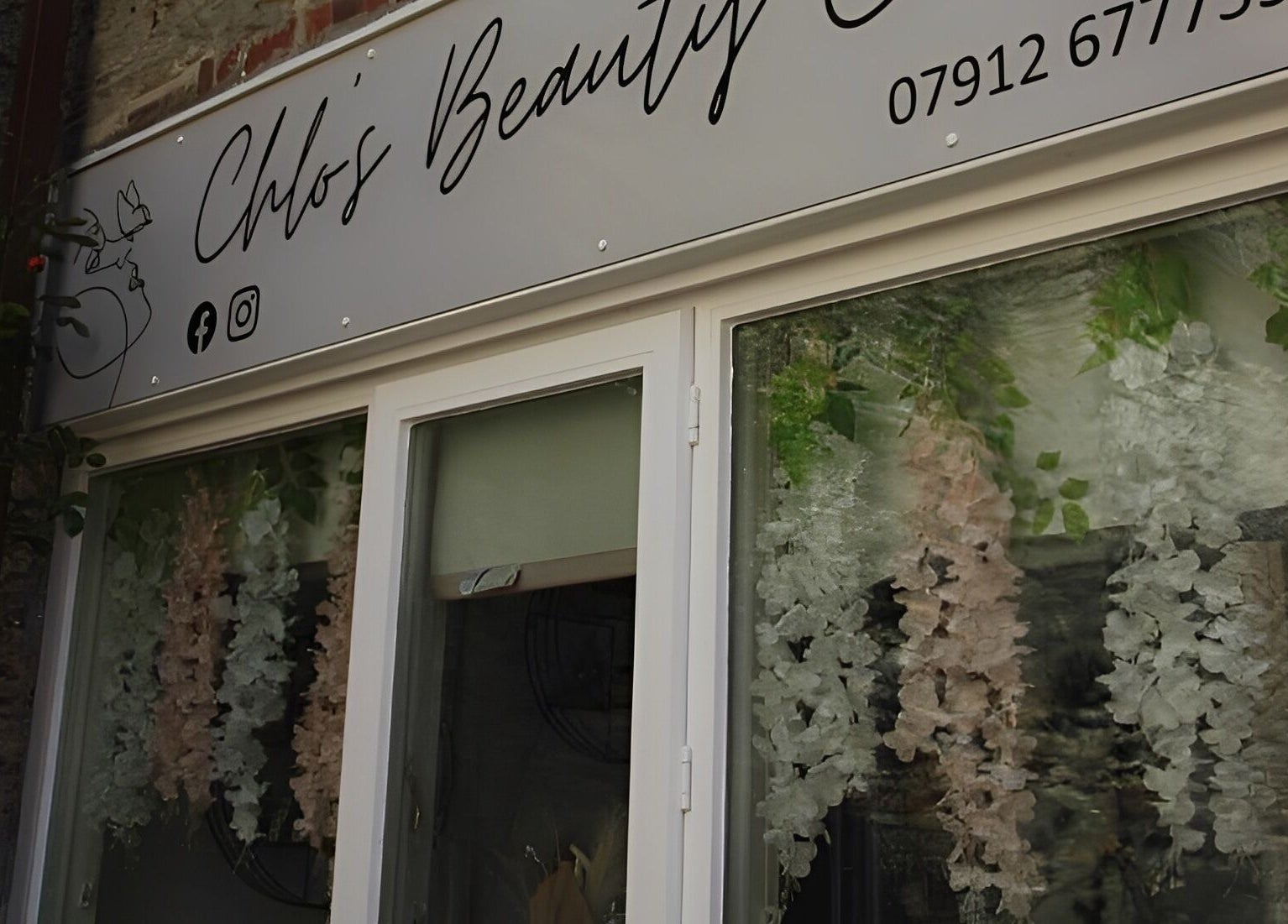 Chlos Beauty Corner entrance with floral decor in Callington, England, GB.