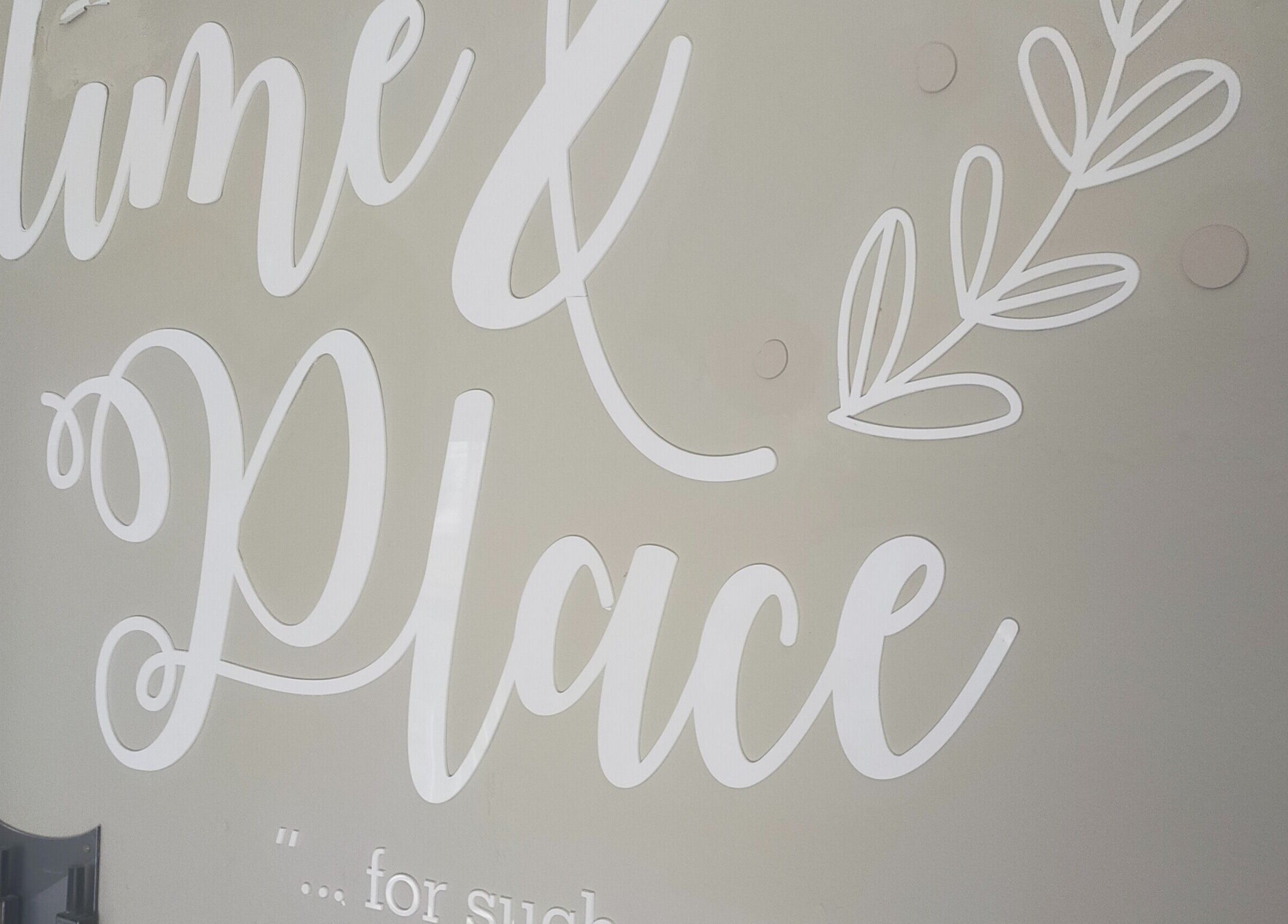 Decorative wall art at Time and Place Beauty in Roodepoort, Gauteng, ZA, featuring a graceful script design.