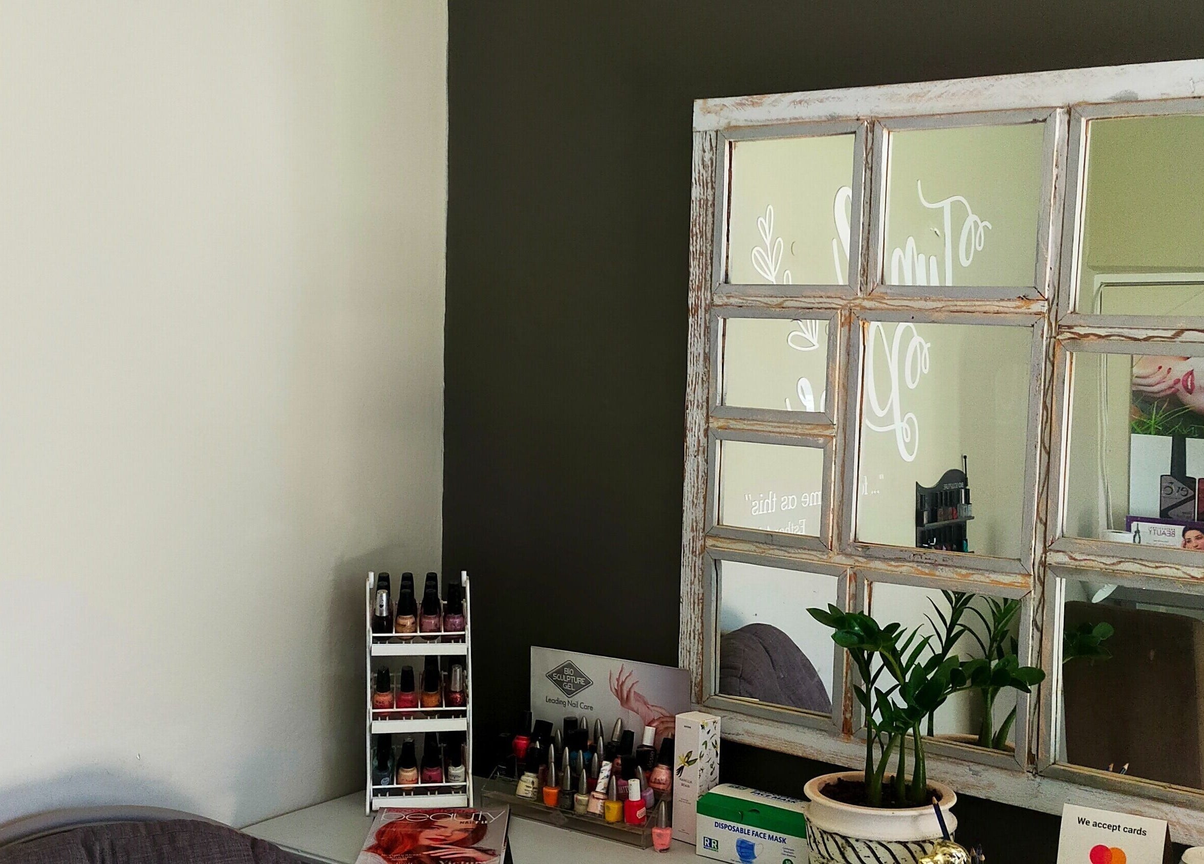 Rustic mirror and nail polish at Time and Place Beauty in Roodepoort, Gauteng, ZA enhancing cozy ambiance.