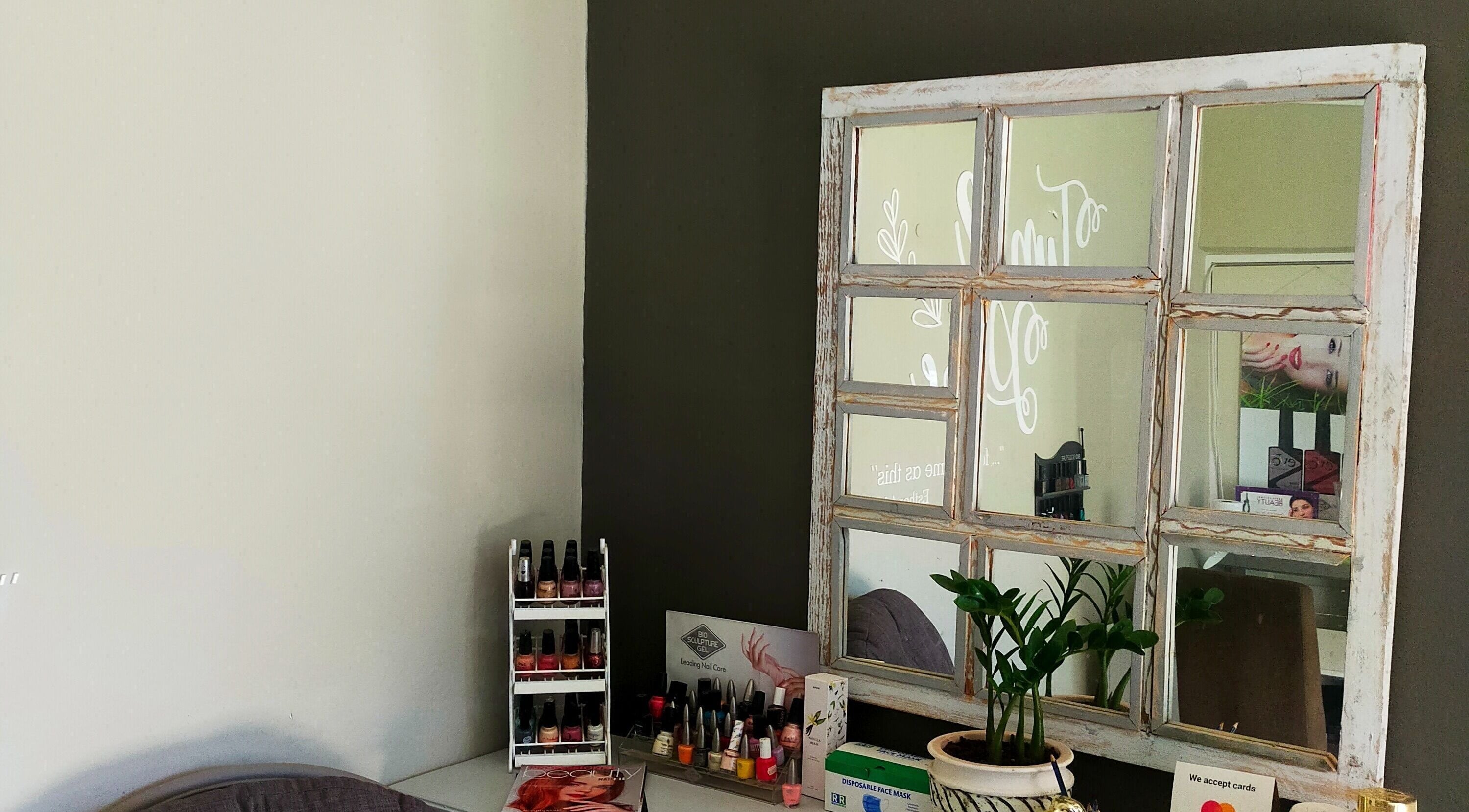 Rustic mirror and nail polish at Time and Place Beauty in Roodepoort, Gauteng, ZA enhancing cozy ambiance.