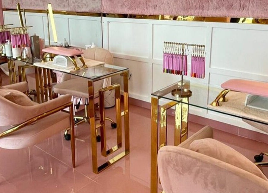 Luxurious pink and gold nail salon at Lynette's in Accra, Greater Accra Region, GH, featuring plush seating.