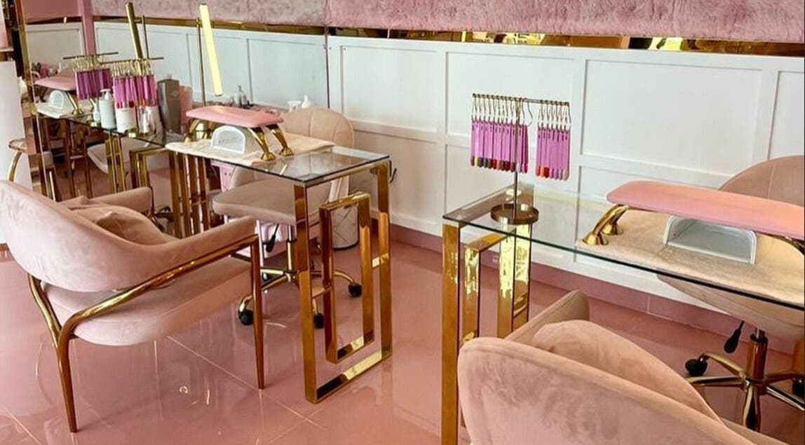 Luxurious pink and gold nail salon at Lynette's in Accra, Greater Accra Region, GH, featuring plush seating.