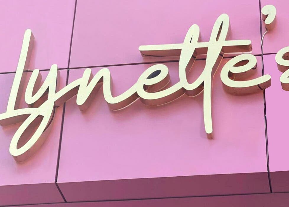 Lynette's elegant signage on pink wall in Accra, Greater Accra Region, GH.