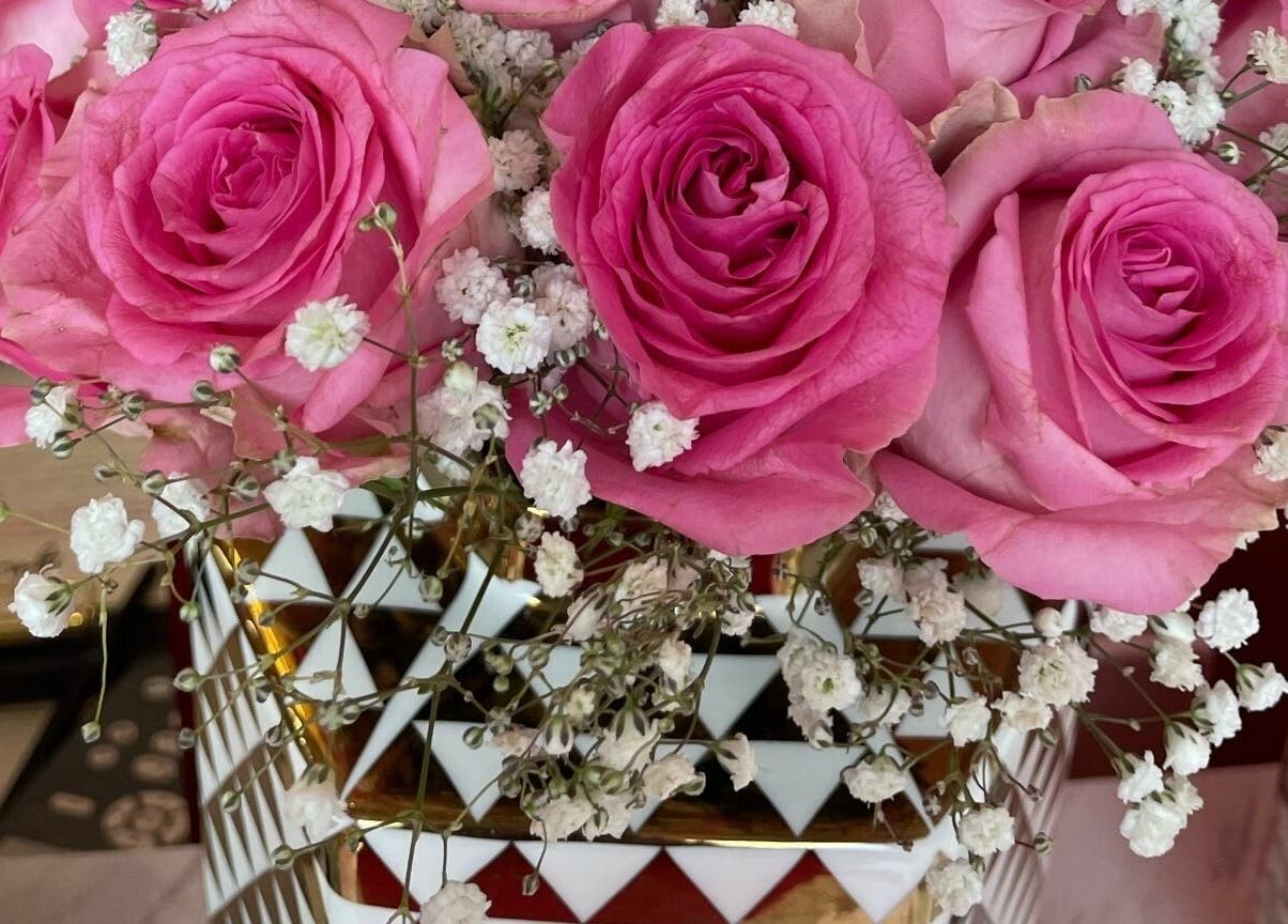 Elegant pink roses in a decorative vase at Lynette's, Accra, Greater Accra Region, GH.