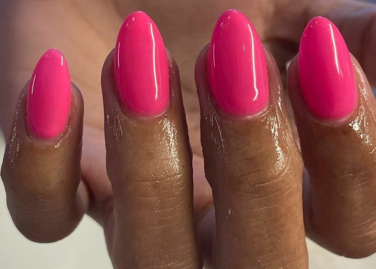 Bright pink manicured nails at Lynette's, Accra, Greater Accra Region, GH, showcasing expert nail art.