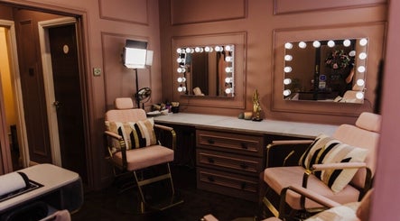 Luxurious makeup station at Vamp Beauty Bar in Westport, County Mayo, IE with plush seating and illuminated mirrors.