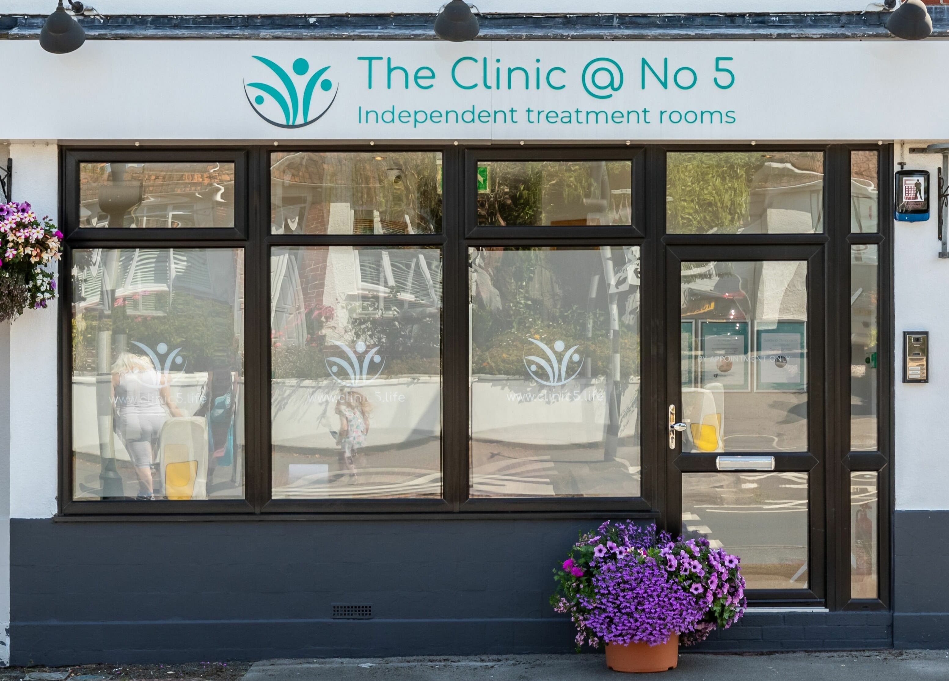 Exterior view of Frontalis Clinic in Portishead, England, GB with welcoming floral decor.