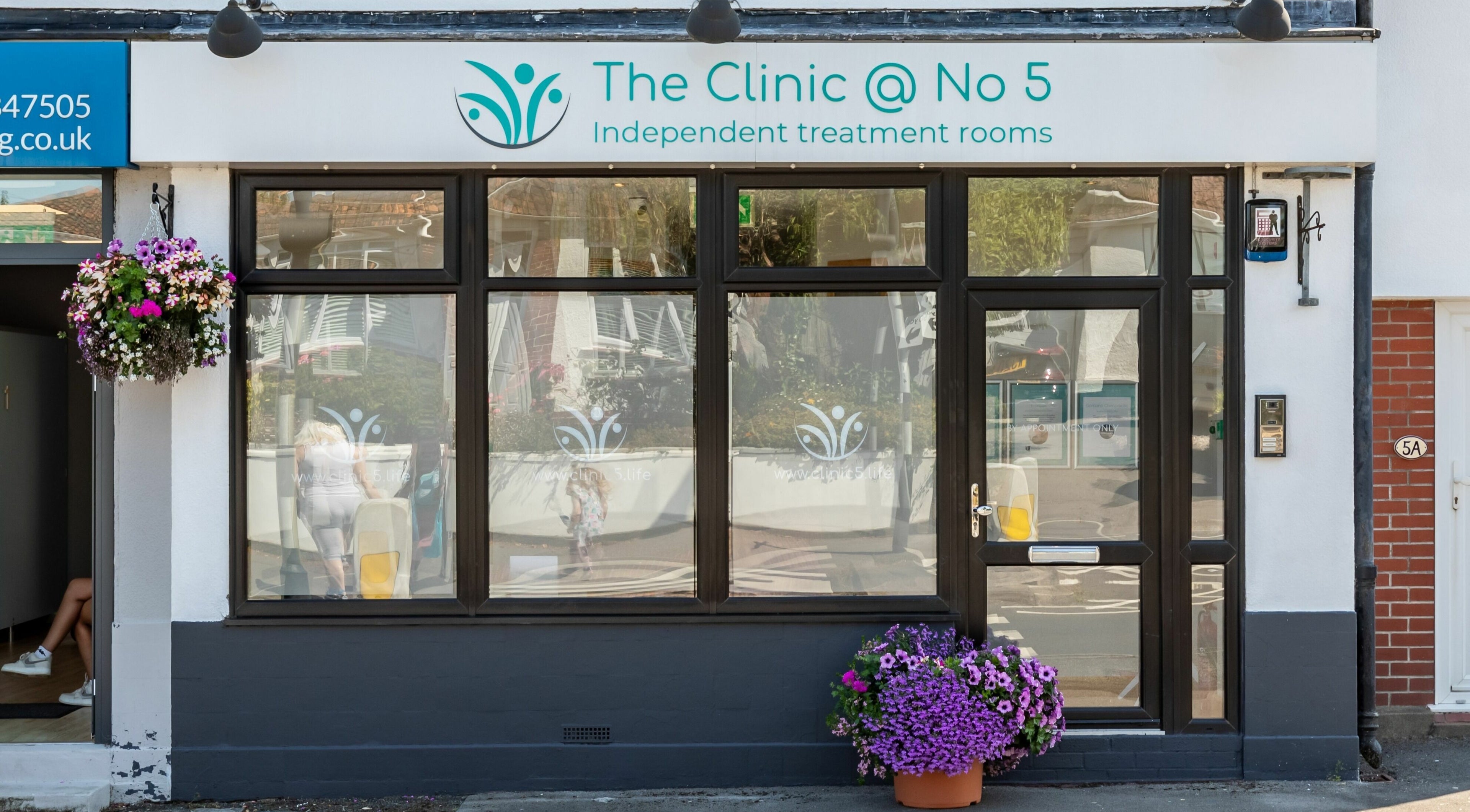 Exterior view of Frontalis Clinic in Portishead, England, GB with welcoming floral decor.