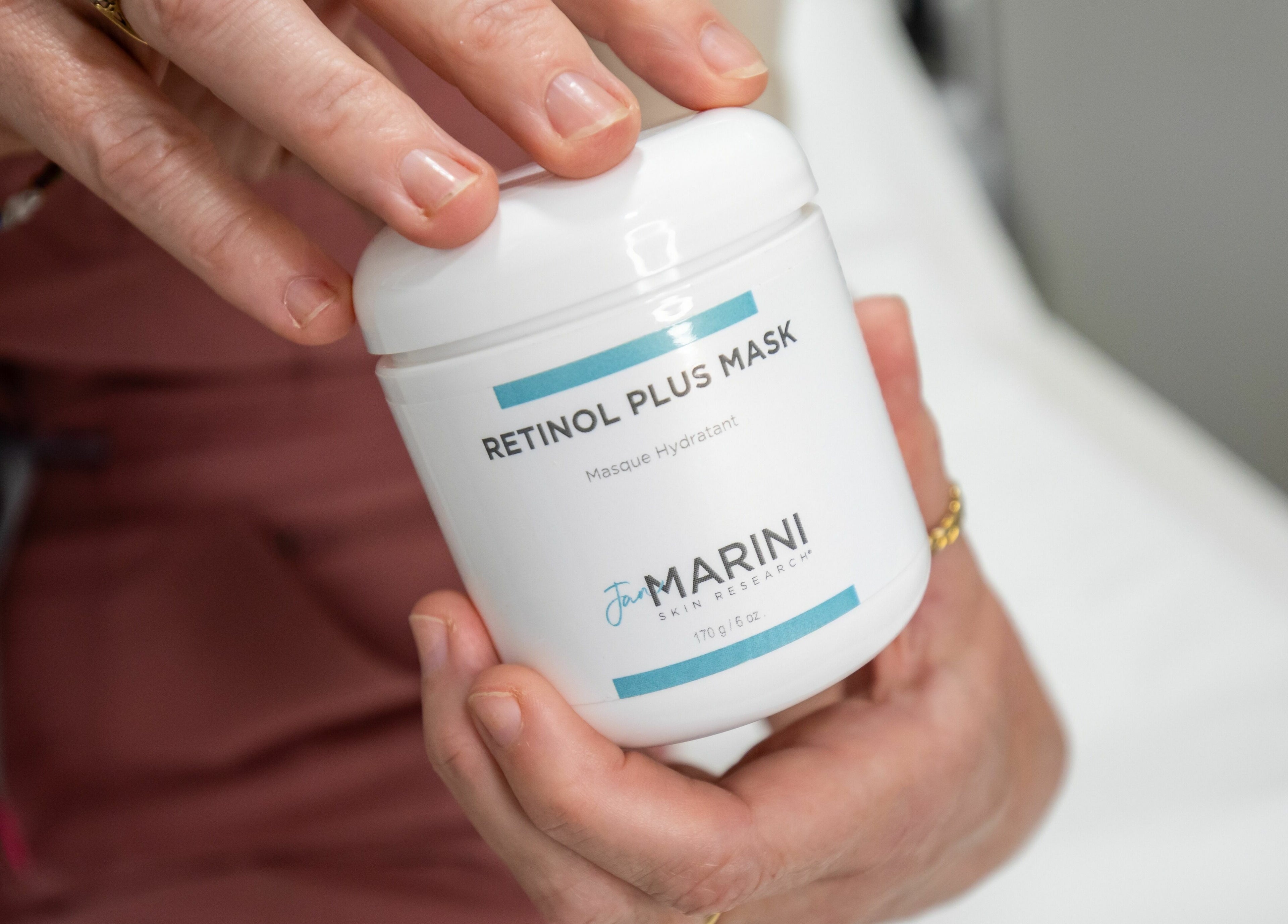 Frontalis Clinic staff holding Retinol Plus Mask at Portishead, England, GB, showcasing skincare product.