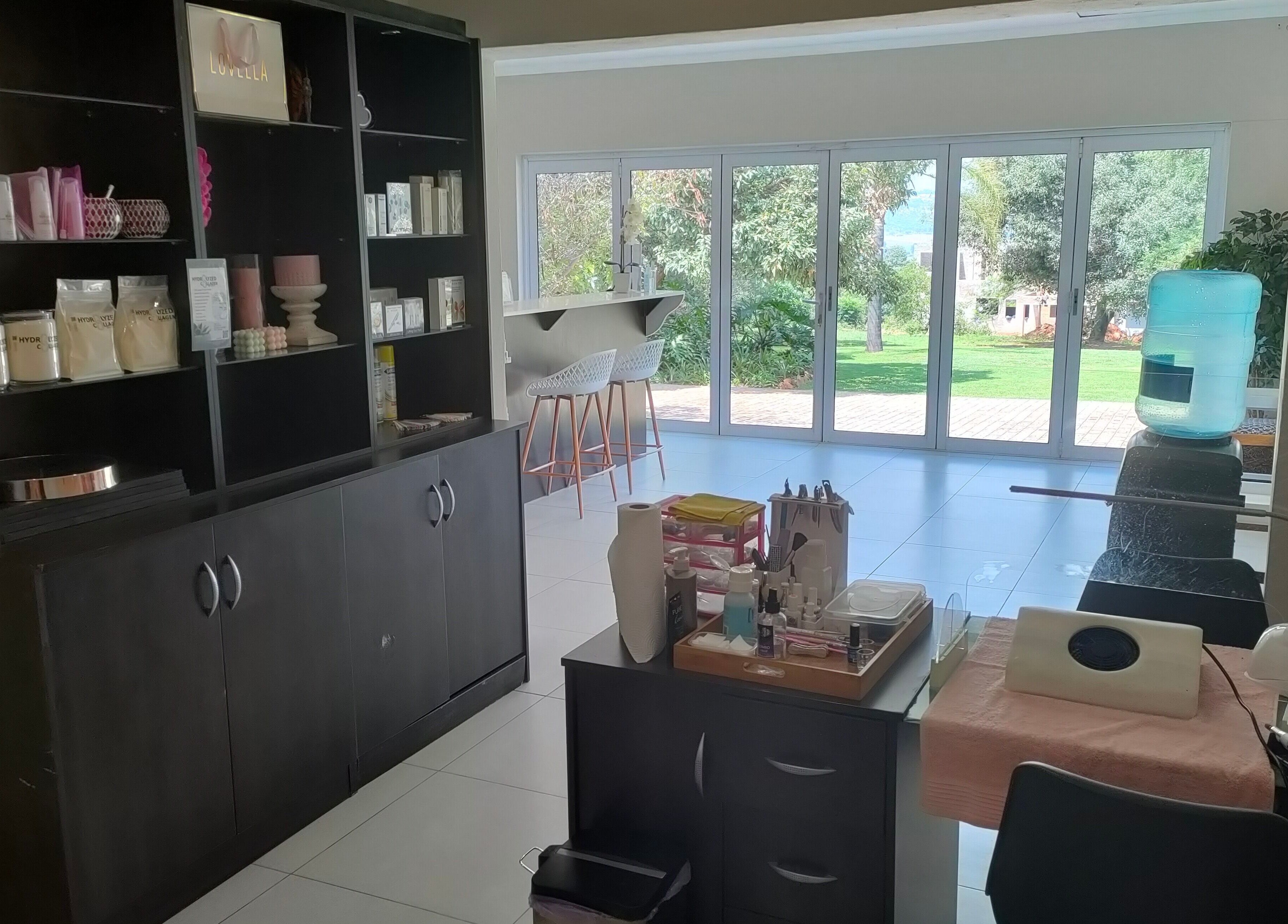 Bright, peaceful interior of Pretty Posh Beauty, Krugersdorp, Gauteng, ZA with elegant decor and lush garden view.