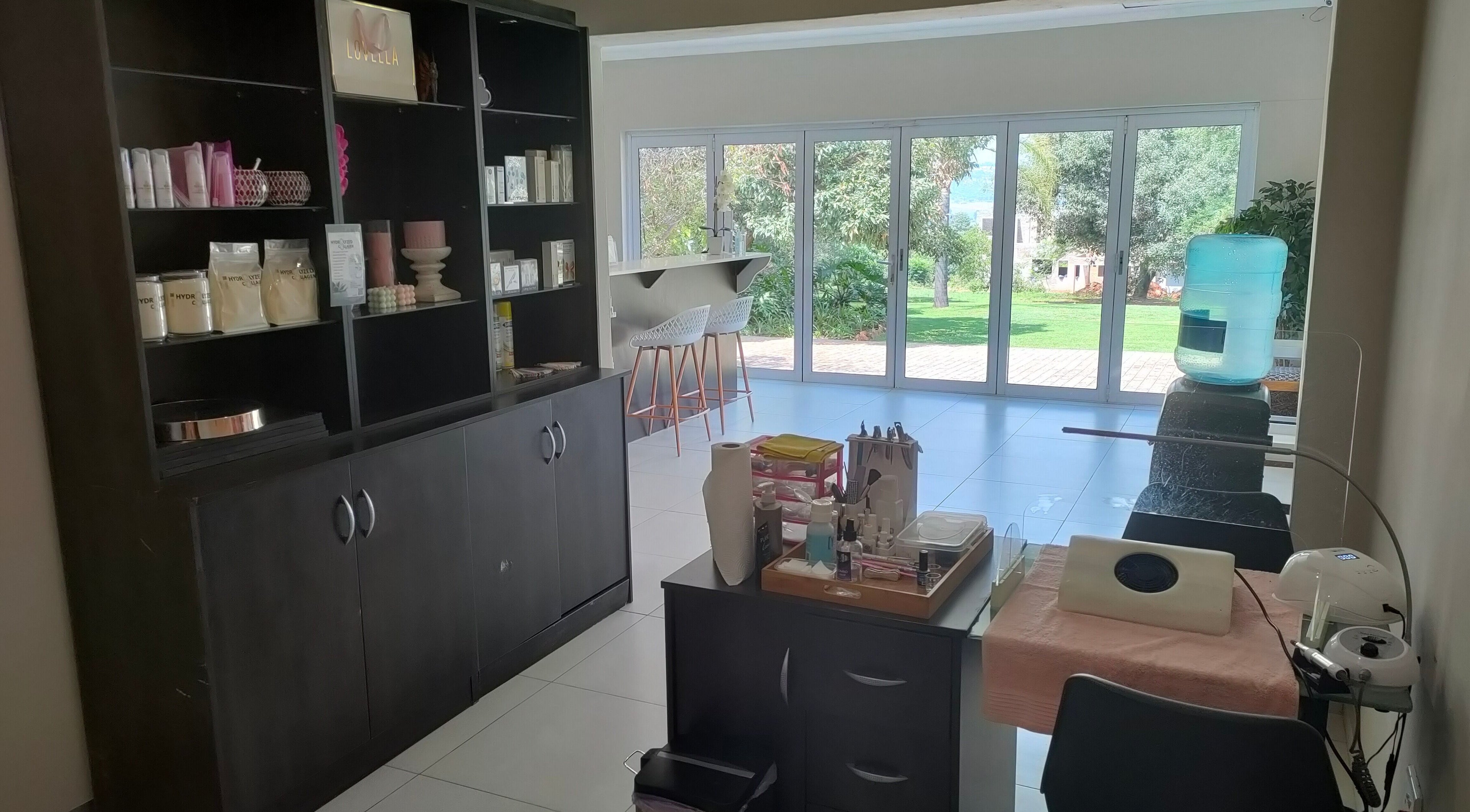 Bright, peaceful interior of Pretty Posh Beauty, Krugersdorp, Gauteng, ZA with elegant decor and lush garden view.