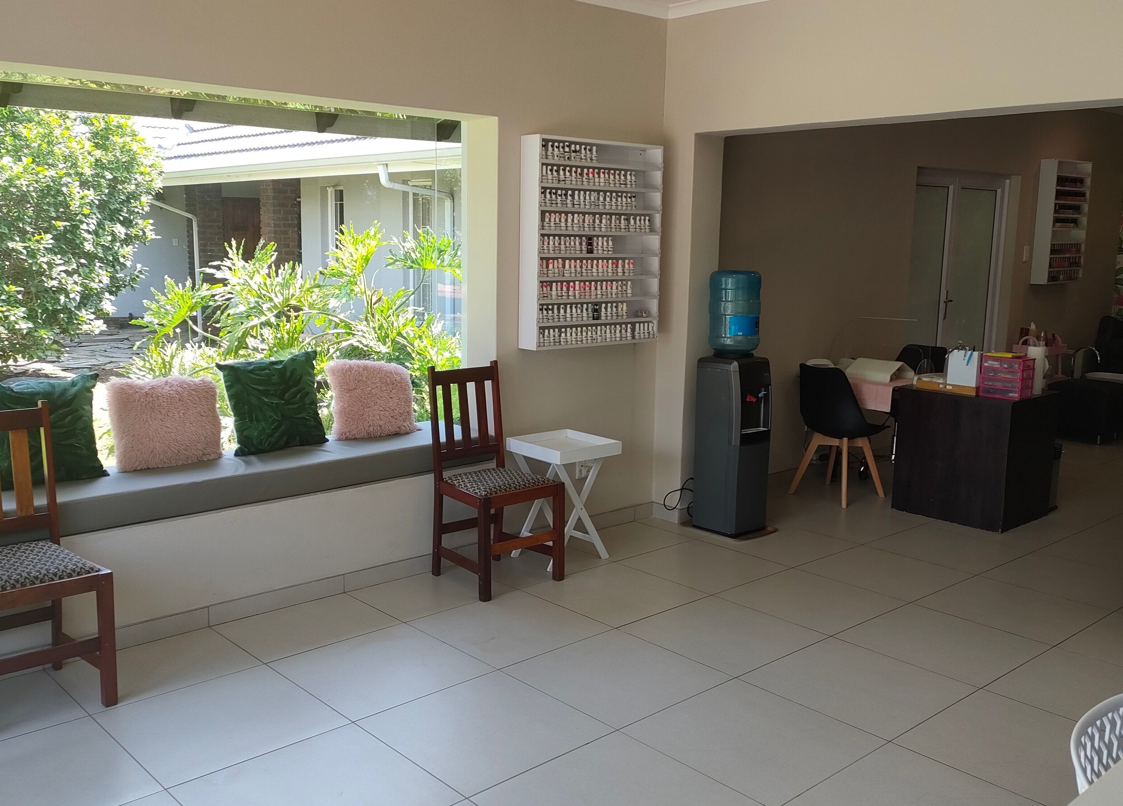 Interior of Pretty Posh Beauty in Krugersdorp, Gauteng, ZA showcasing bright, stylish seating for relaxation.