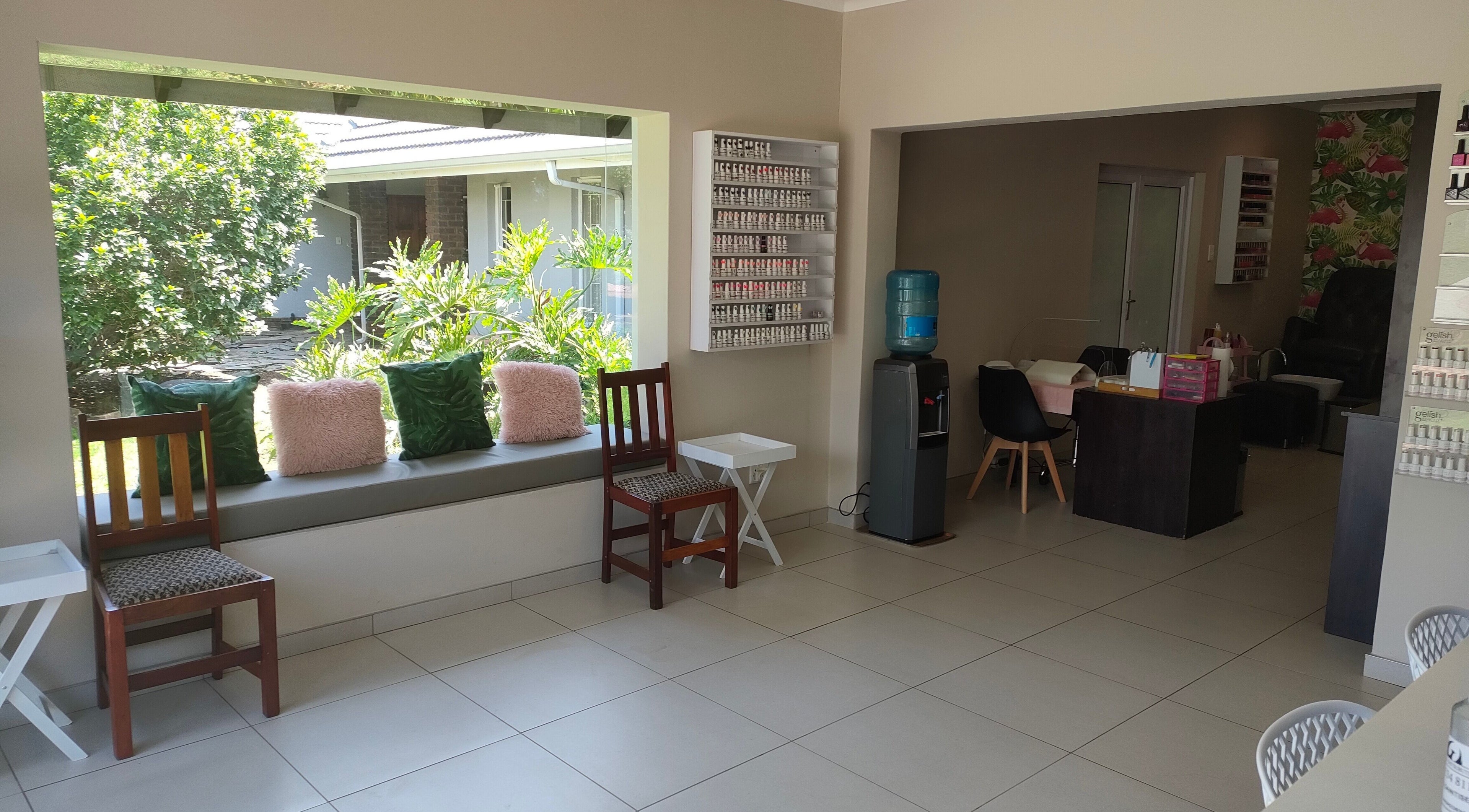 Interior of Pretty Posh Beauty in Krugersdorp, Gauteng, ZA showcasing bright, stylish seating for relaxation.