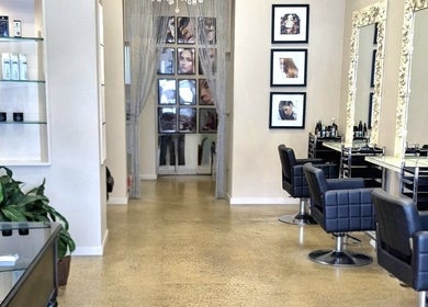 Elegant salon interior at Allure Hair and Co - By Christina, Coburg, Victoria, AU, featuring stylish black chairs.