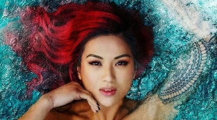 Vibrant red-haired woman in water at Allure Hair and Co - By Christina, Coburg, Victoria, AU.