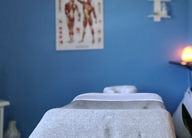 Relaxing massage room at Care Massage Therapy (Carrie Leake RMT) in Niagara Falls, Ontario, CA with soft lighting.