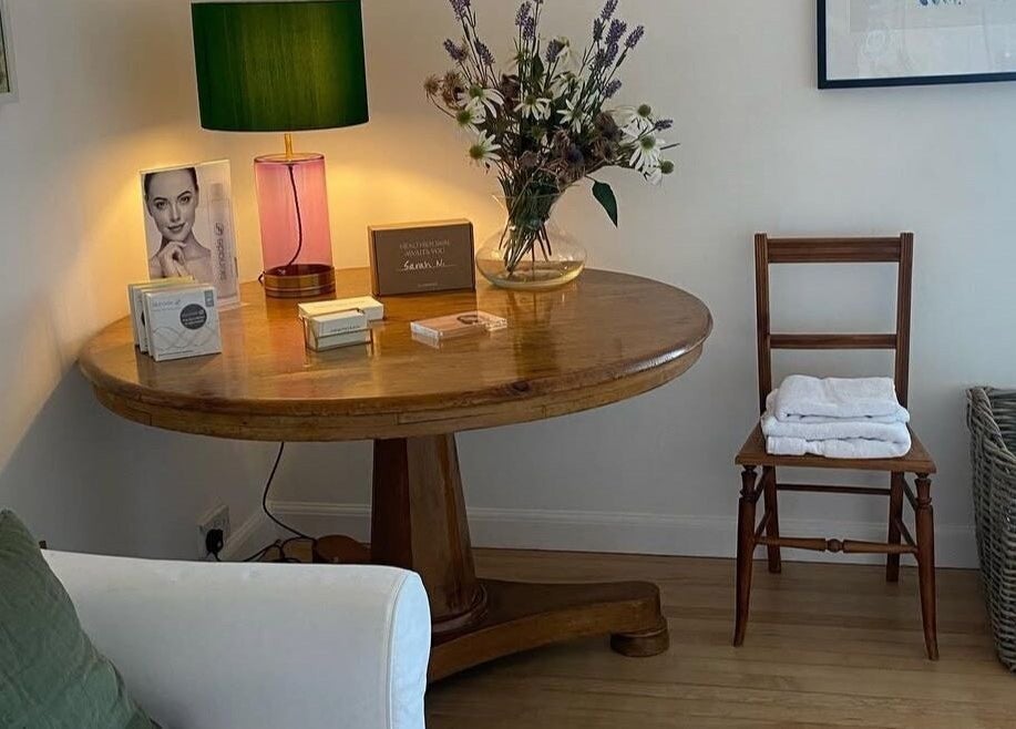Inviting spa corner at Sarah Nicolson Facialist, Ewenny, GB, featuring a wooden table and elegant decor.