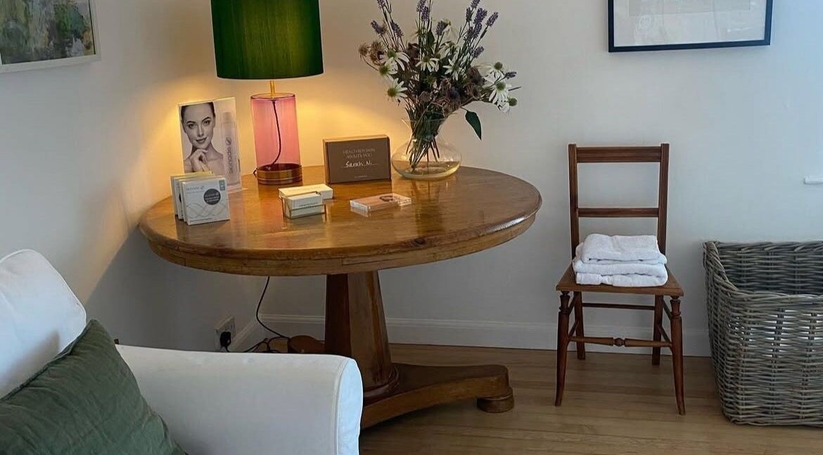 Inviting spa corner at Sarah Nicolson Facialist, Ewenny, GB, featuring a wooden table and elegant decor.