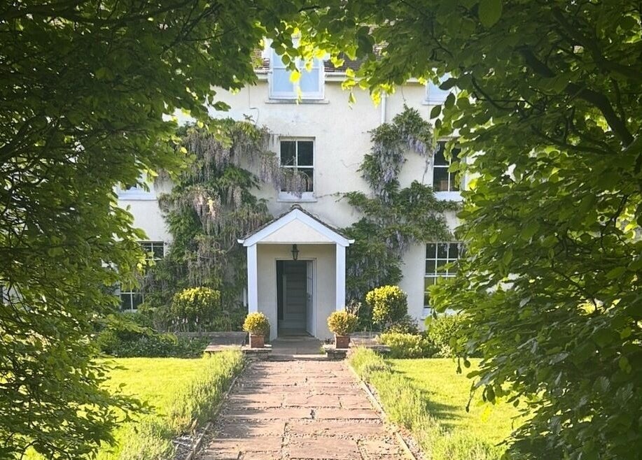 Charming garden path leads to Sarah Nicolson Facialist venue in Ewenny, GB surrounded by lush greenery.