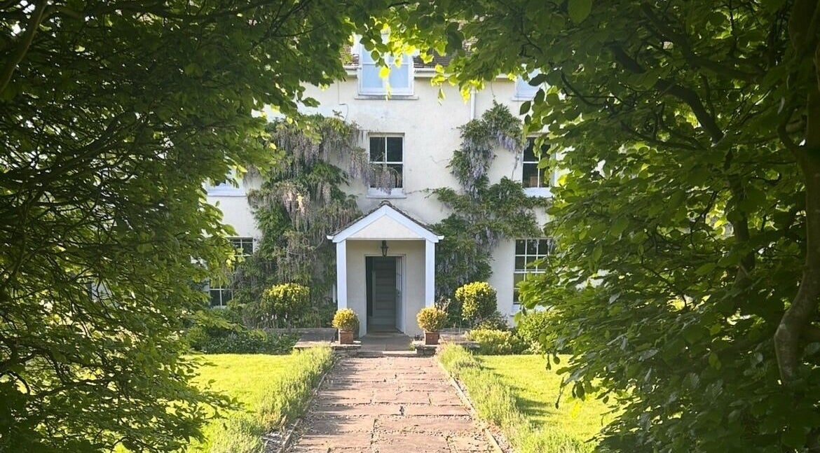 Charming garden path leads to Sarah Nicolson Facialist venue in Ewenny, GB surrounded by lush greenery.