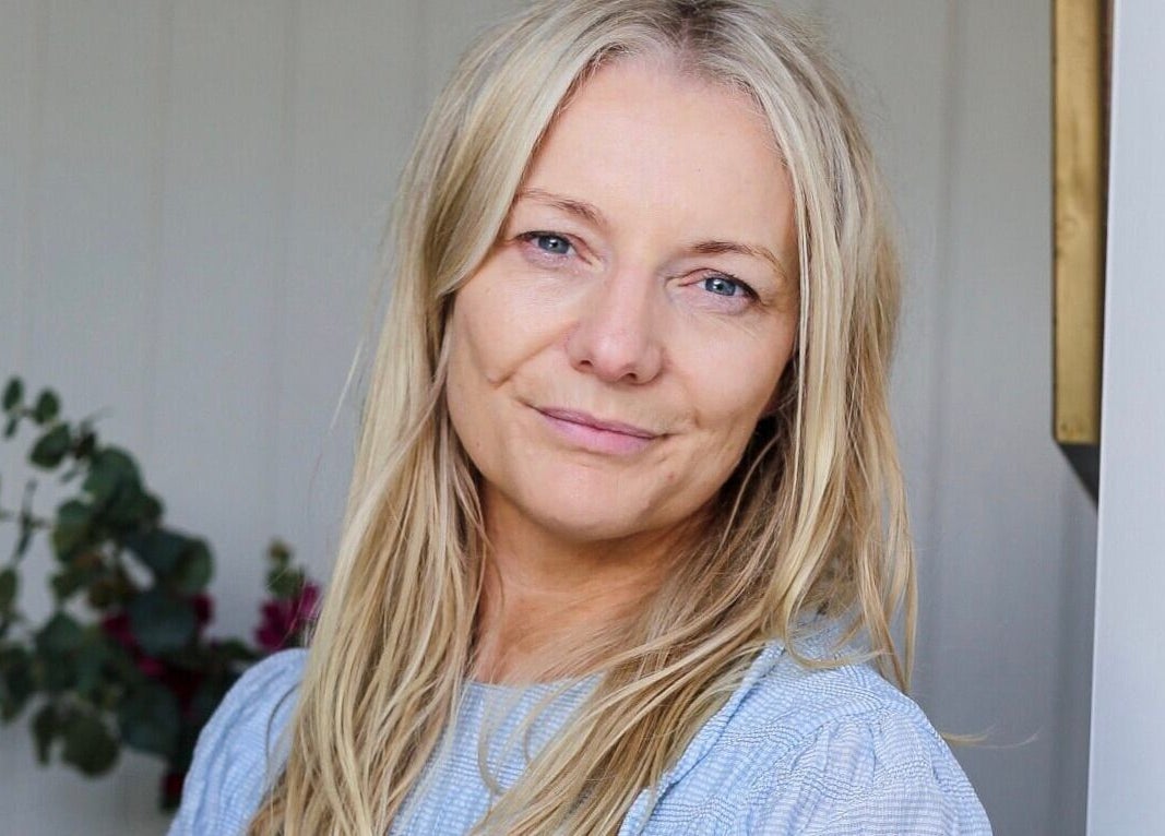 Smiling woman at Sarah Nicolson Facialist in Ewenny, GB, highlighting natural beauty and wellness expertise.