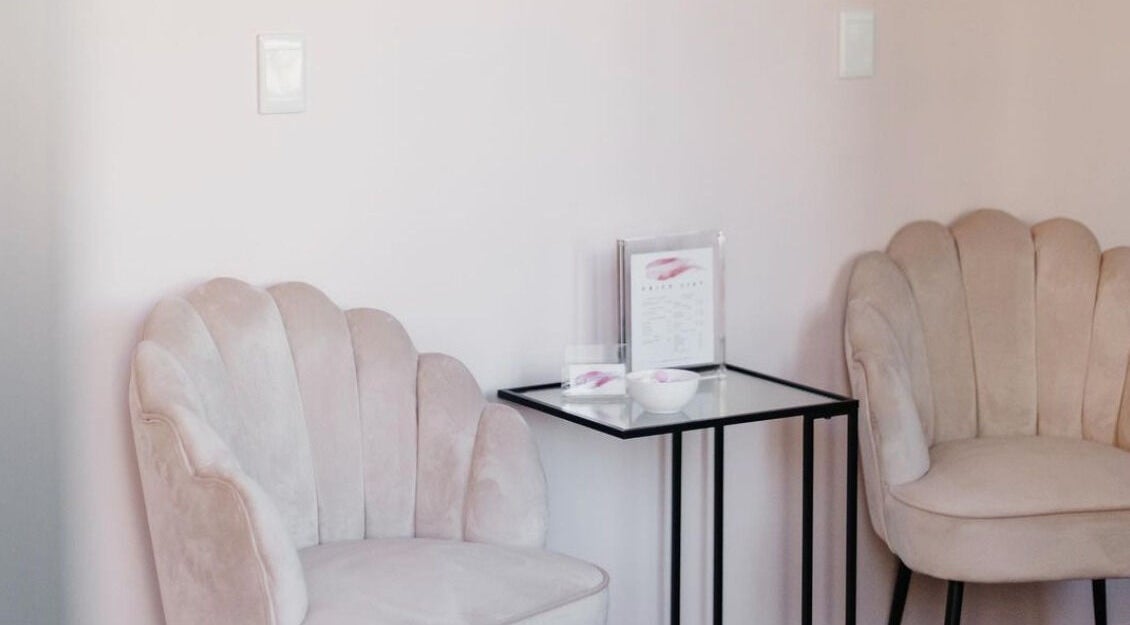 Elegant seating area at The Brow Specialist, Somerset West, Western Cape, ZA with plush chairs and side table.