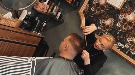 A barber giving a stylish haircut at The LadyBarber’s Shop in New Bradwell, England, GB.