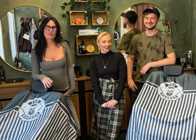 Stylish team at The LadyBarber’s Shop in New Bradwell, England, GB, showcasing modern barber chairs.
