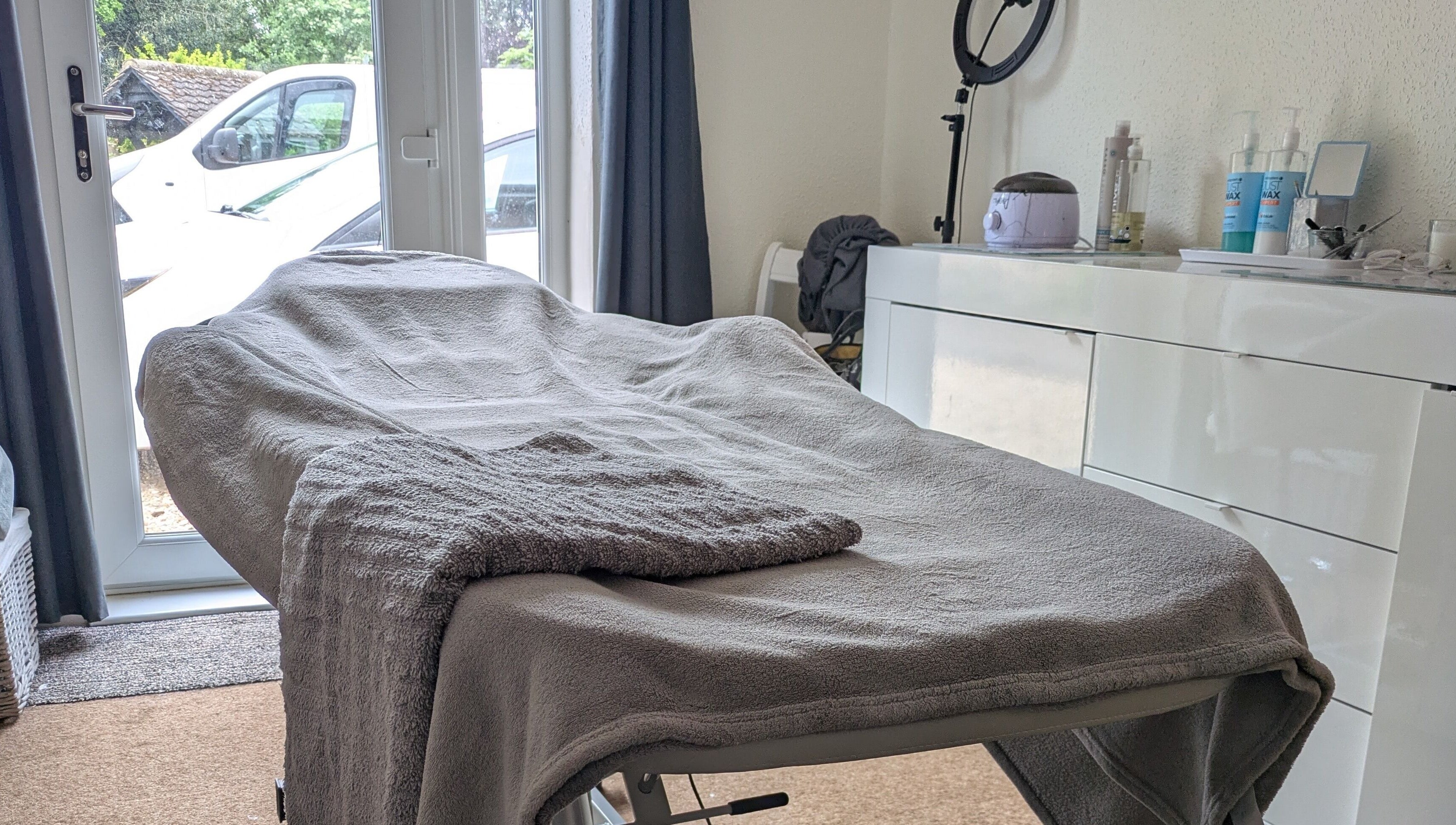 Relaxing treatment room at Beauty by Bex in March, England, GB, with cozy massage bed and calming decor.