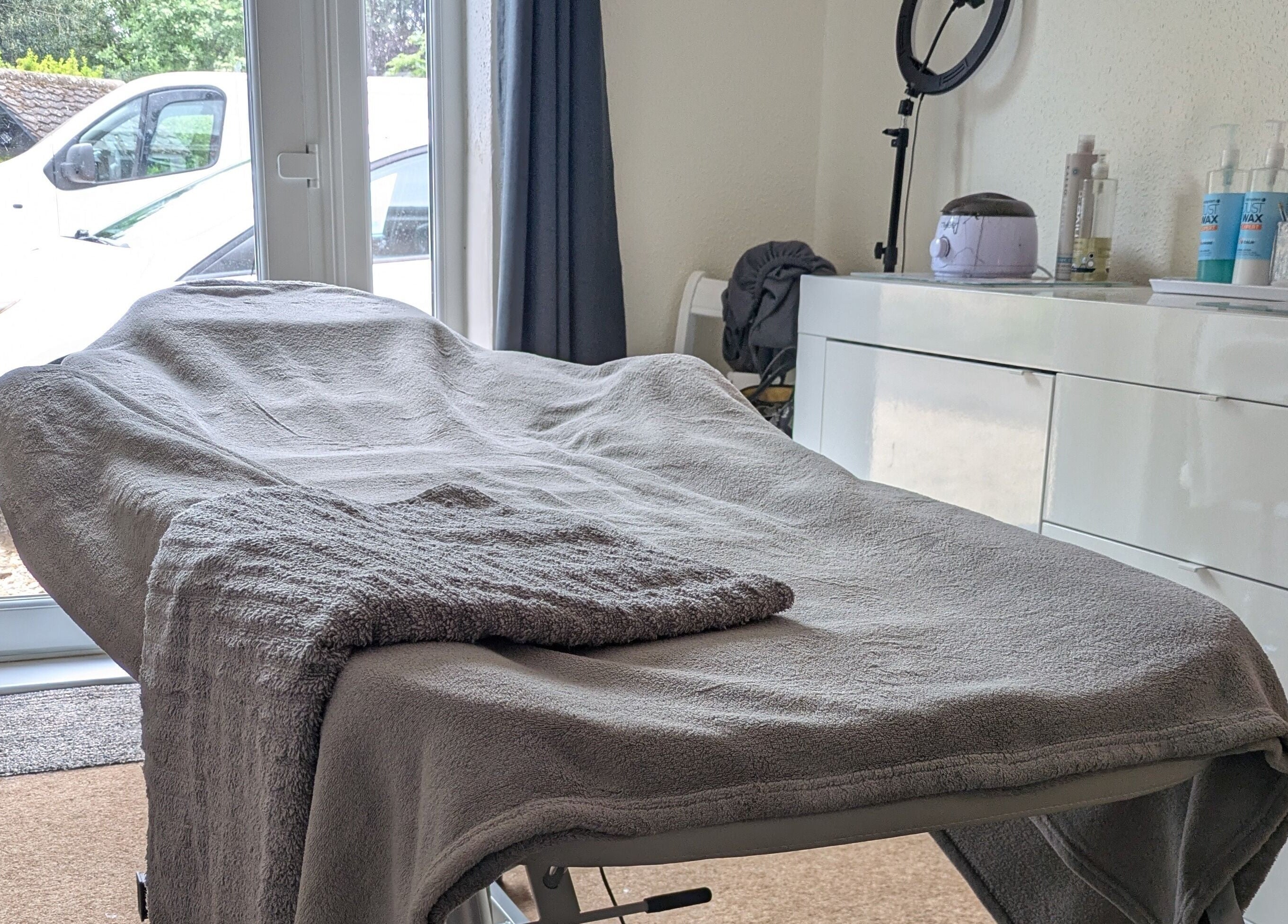 Relaxing treatment room at Beauty by Bex in March, England, GB, with cozy massage bed and calming decor.