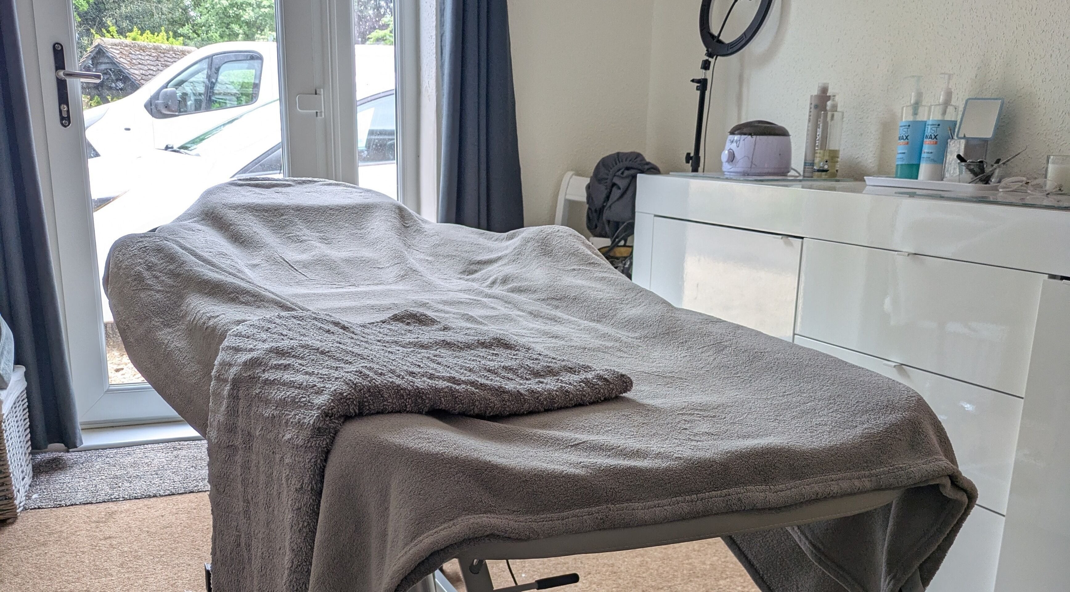 Relaxing treatment room at Beauty by Bex in March, England, GB, with cozy massage bed and calming decor.