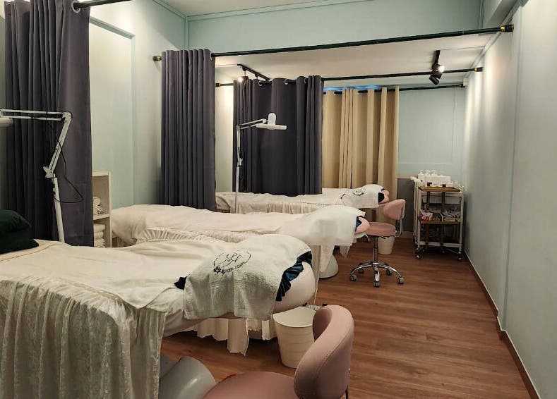 Calm and inviting treatment room at R&R Beauty Studio, Singapore, SG featuring spa beds and soft lighting.