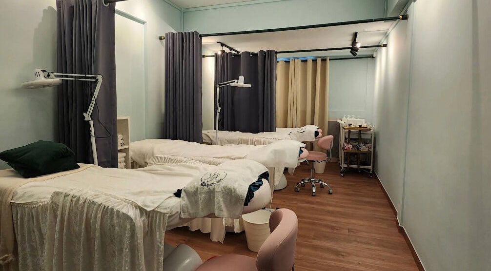 Calm and inviting treatment room at R&R Beauty Studio, Singapore, SG featuring spa beds and soft lighting.