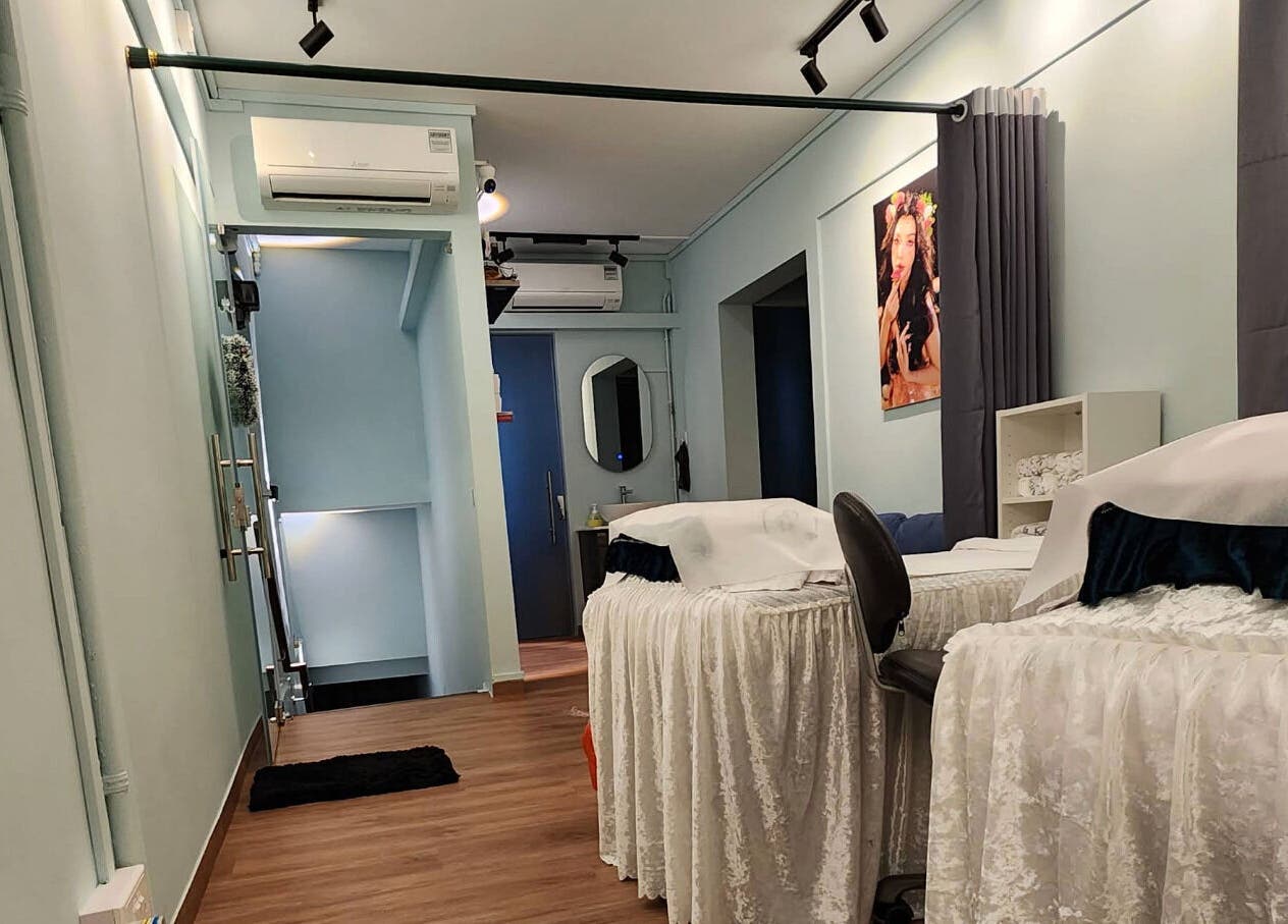 Calming interior of R&R Beauty Studio in Singapore, SG, featuring treatment beds and elegant decor.