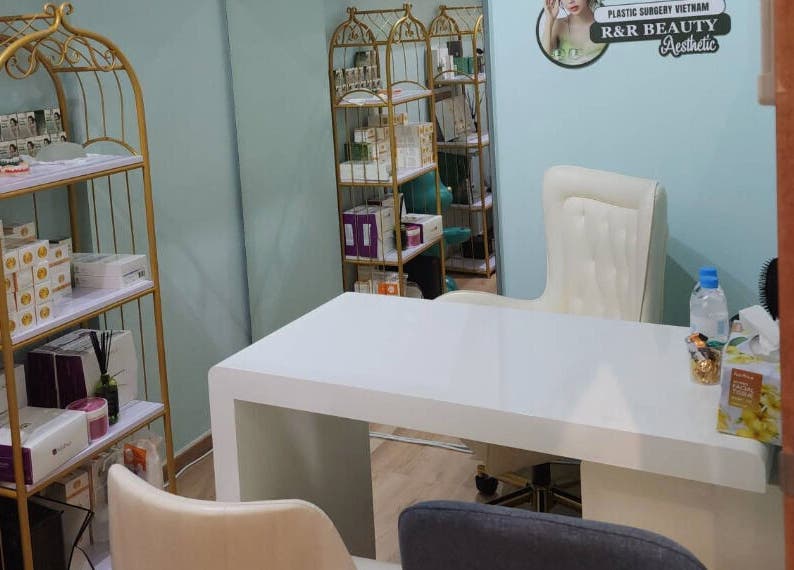 Elegant treatment room at R&R Beauty Studio, Singapore, SG with plush chairs and product shelves.