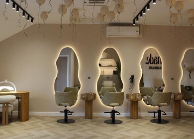 Modern salon at Millie at Shade Harrogate, Harrogate, England featuring elegant mirrors and stylish chairs.