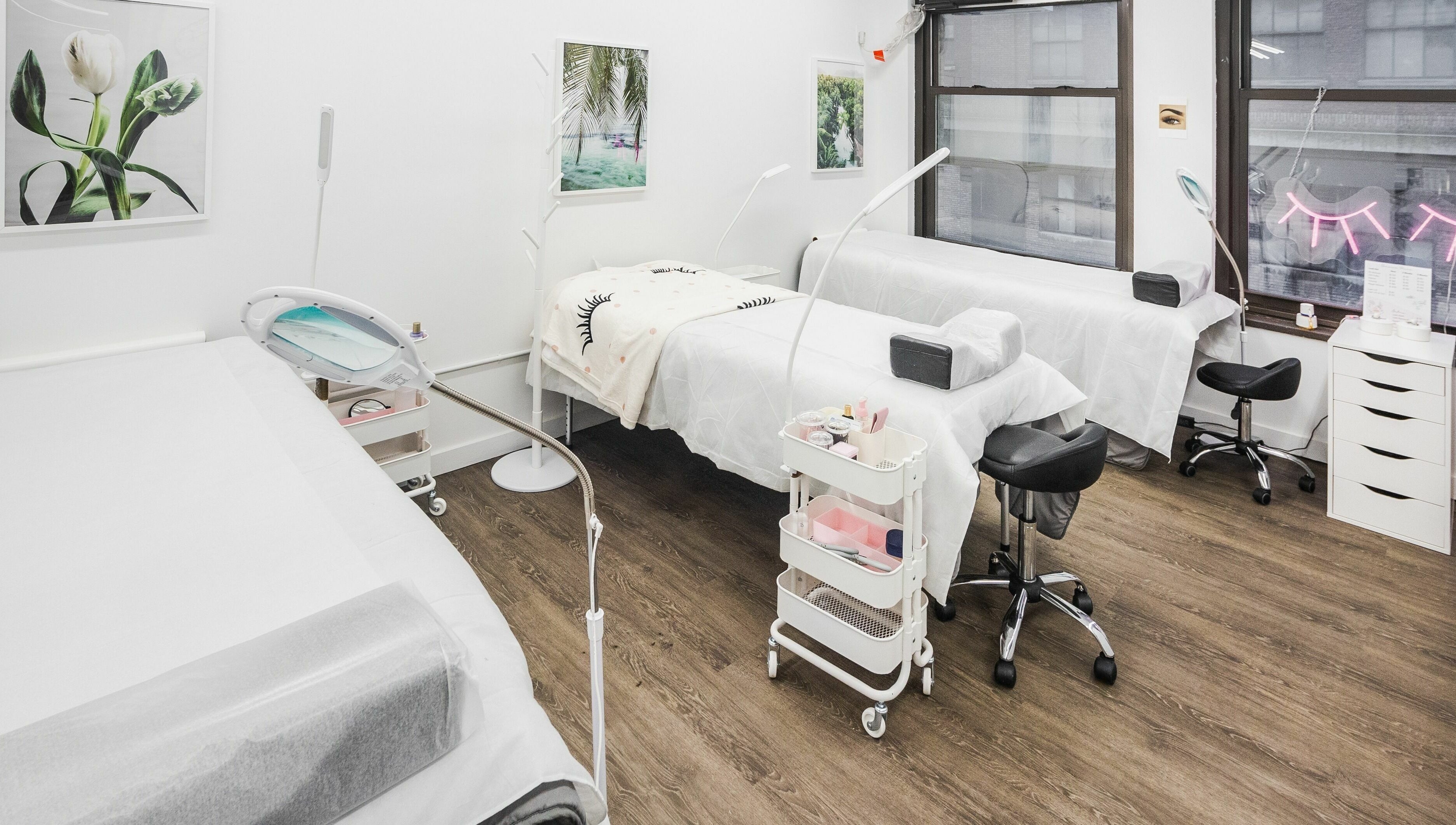 Bright treatment area at V Lash Studio, New York, New York, US featuring comfortable beds and stylish decor.