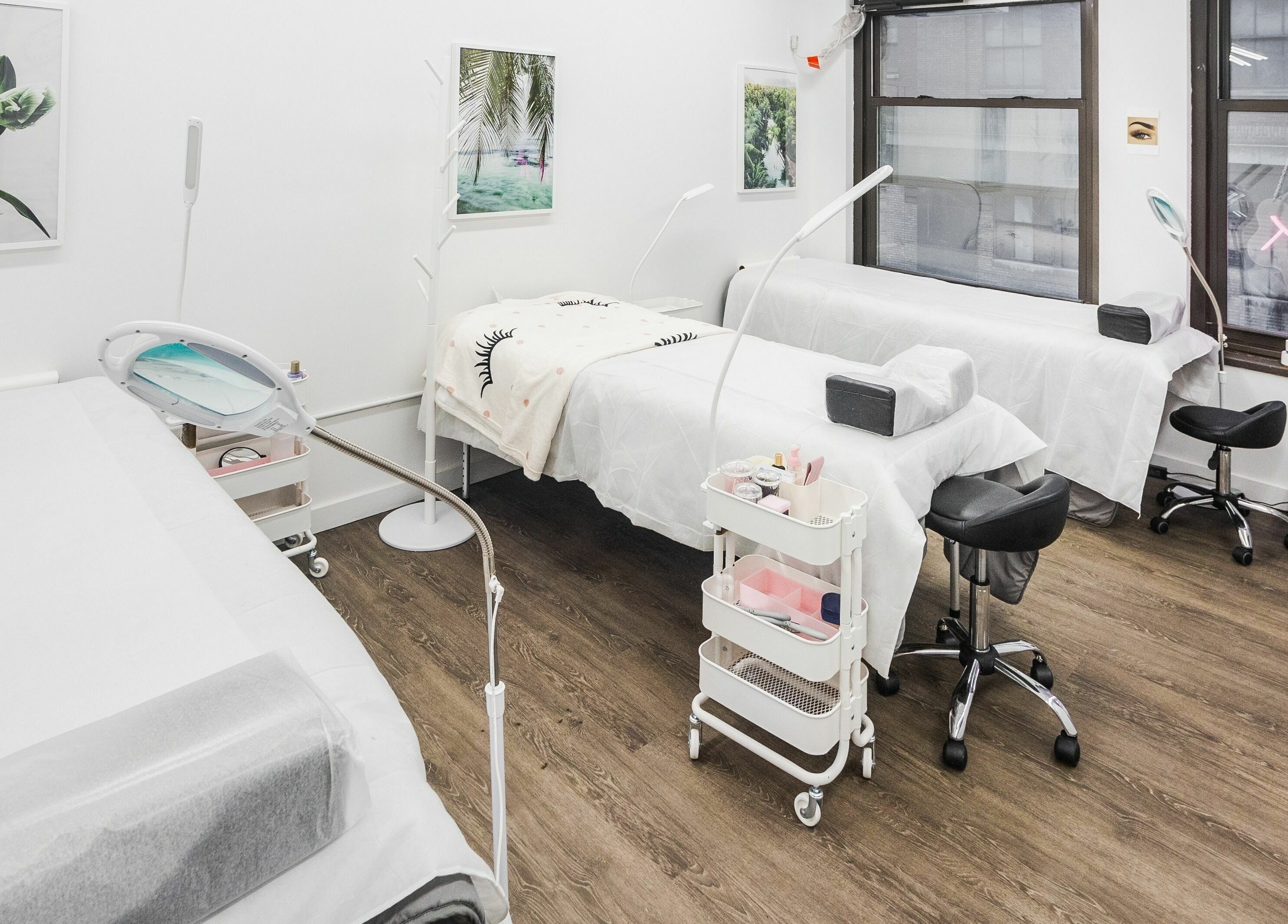 Bright treatment area at V Lash Studio, New York, New York, US featuring comfortable beds and stylish decor.