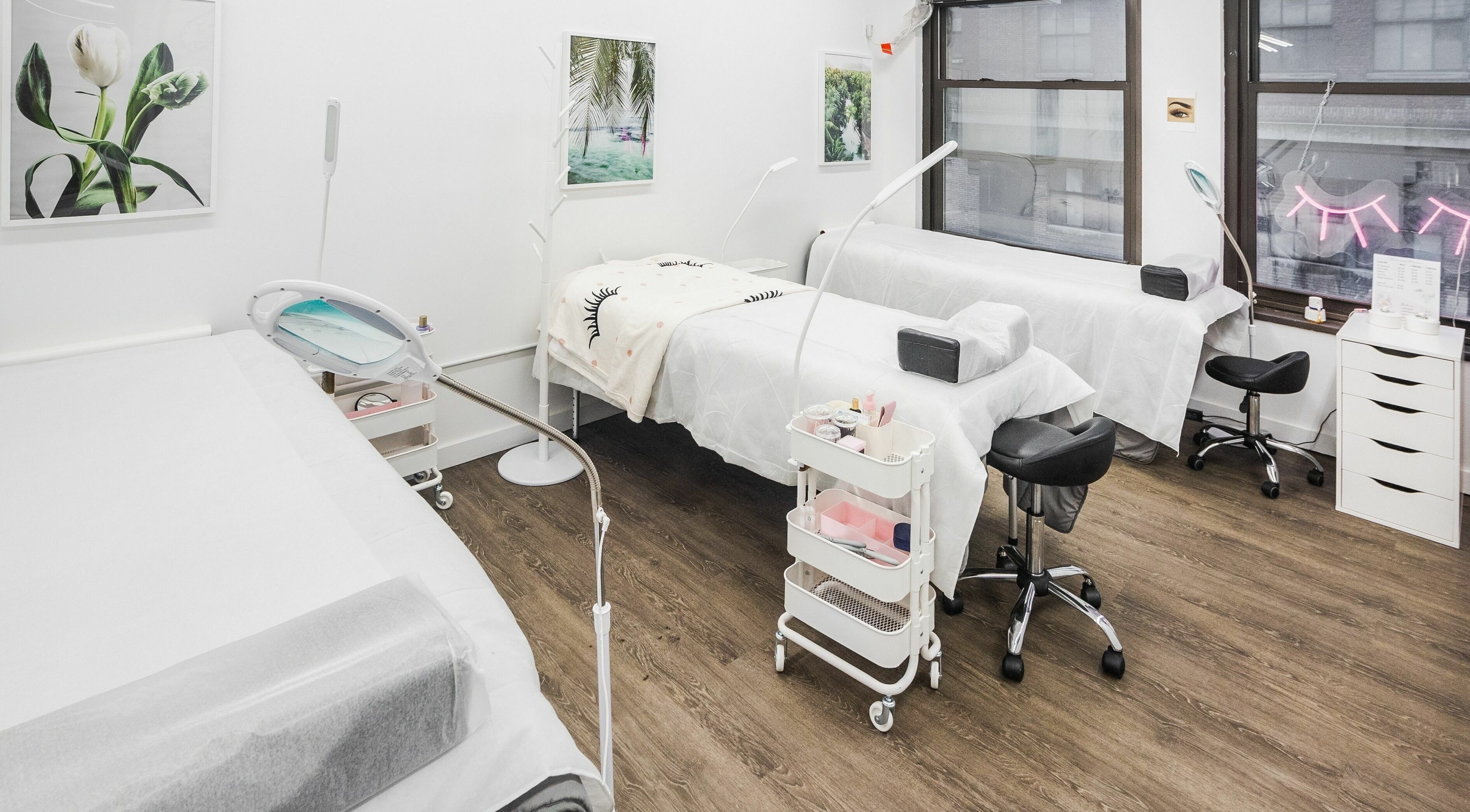 Bright treatment area at V Lash Studio, New York, New York, US featuring comfortable beds and stylish decor.