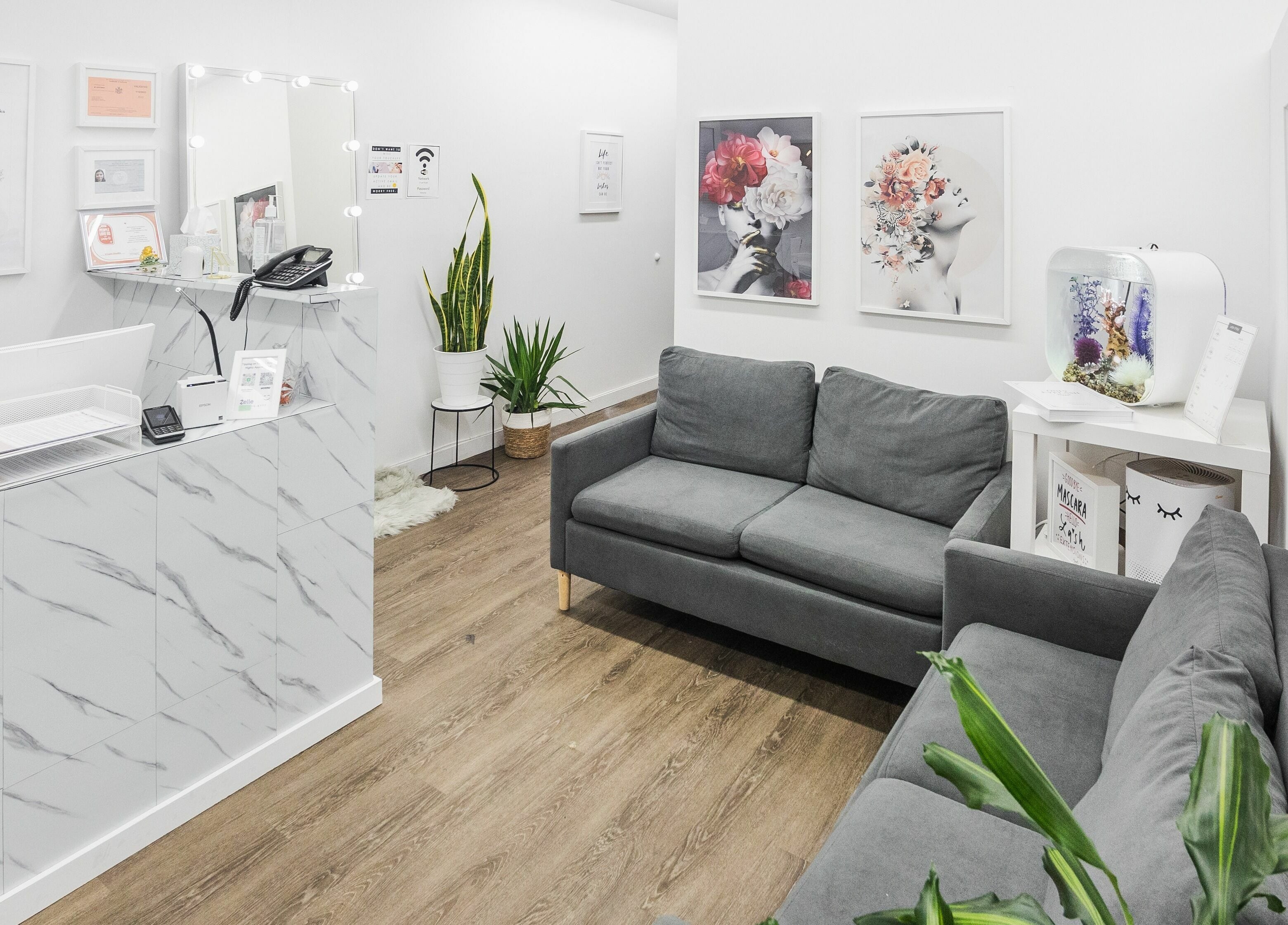 Inviting reception area of V Lash Studio in New York, New York, US, featuring modern decor and cozy seating.