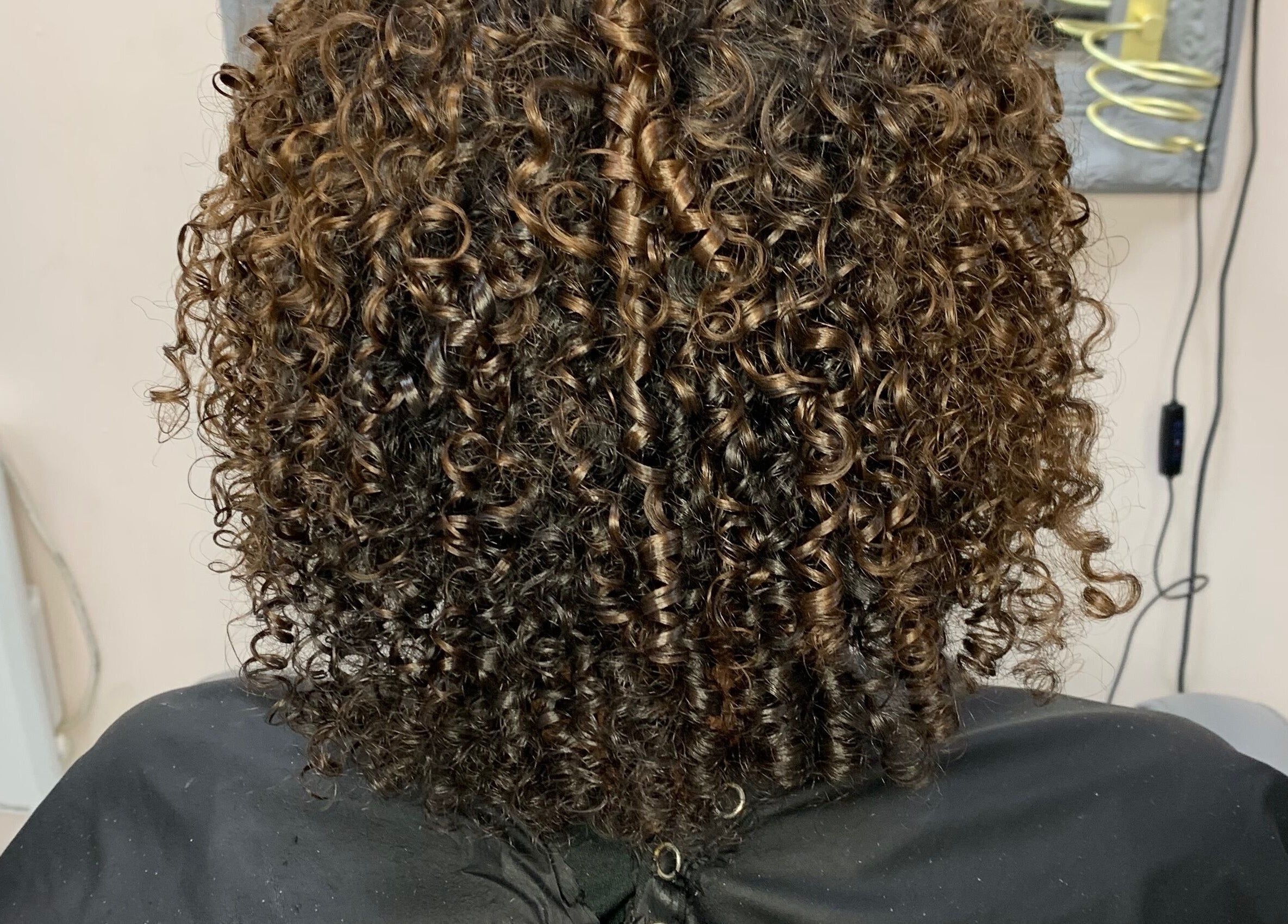 Beautifully styled curly hair at Manes by Morgan in Willenhall, England, GB.