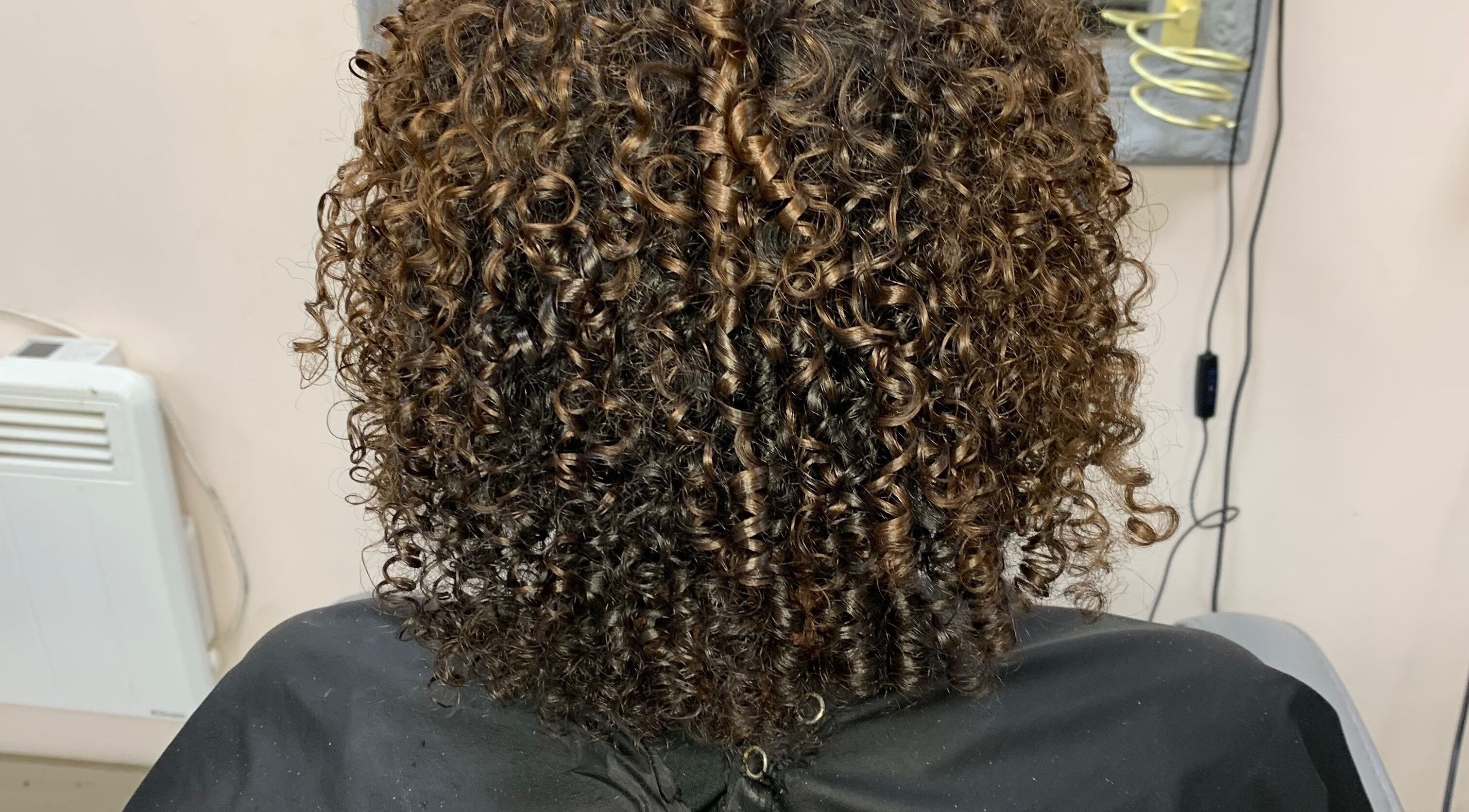 Beautifully styled curly hair at Manes by Morgan in Willenhall, England, GB.