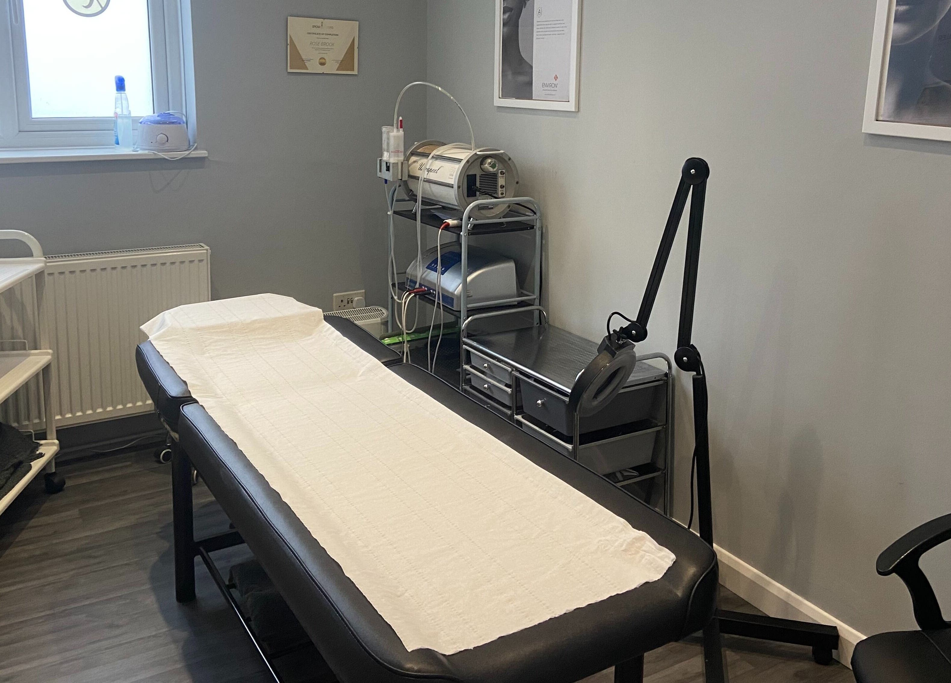 Revive Laser Clinic's serene treatment room in Snodland, England, GB, featuring a comfortable bed and modern equipment.