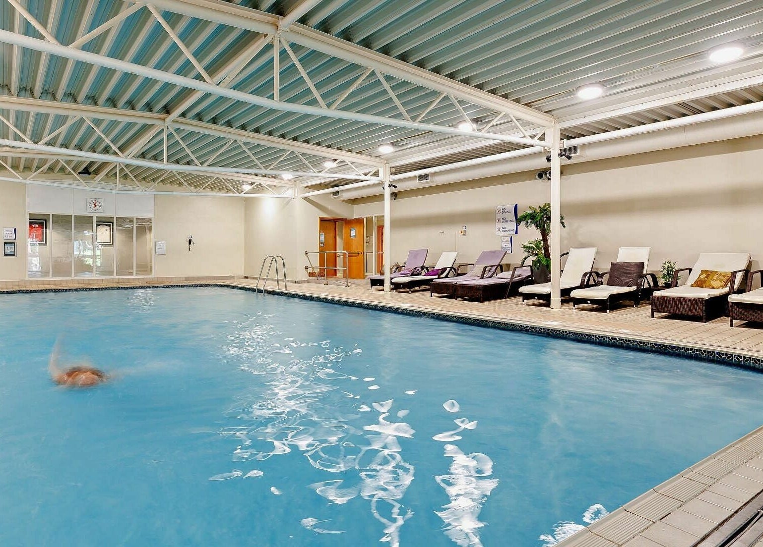 Indoor pool with loungers at Natural Light Spa and Wellness, Guildford, England, GB.