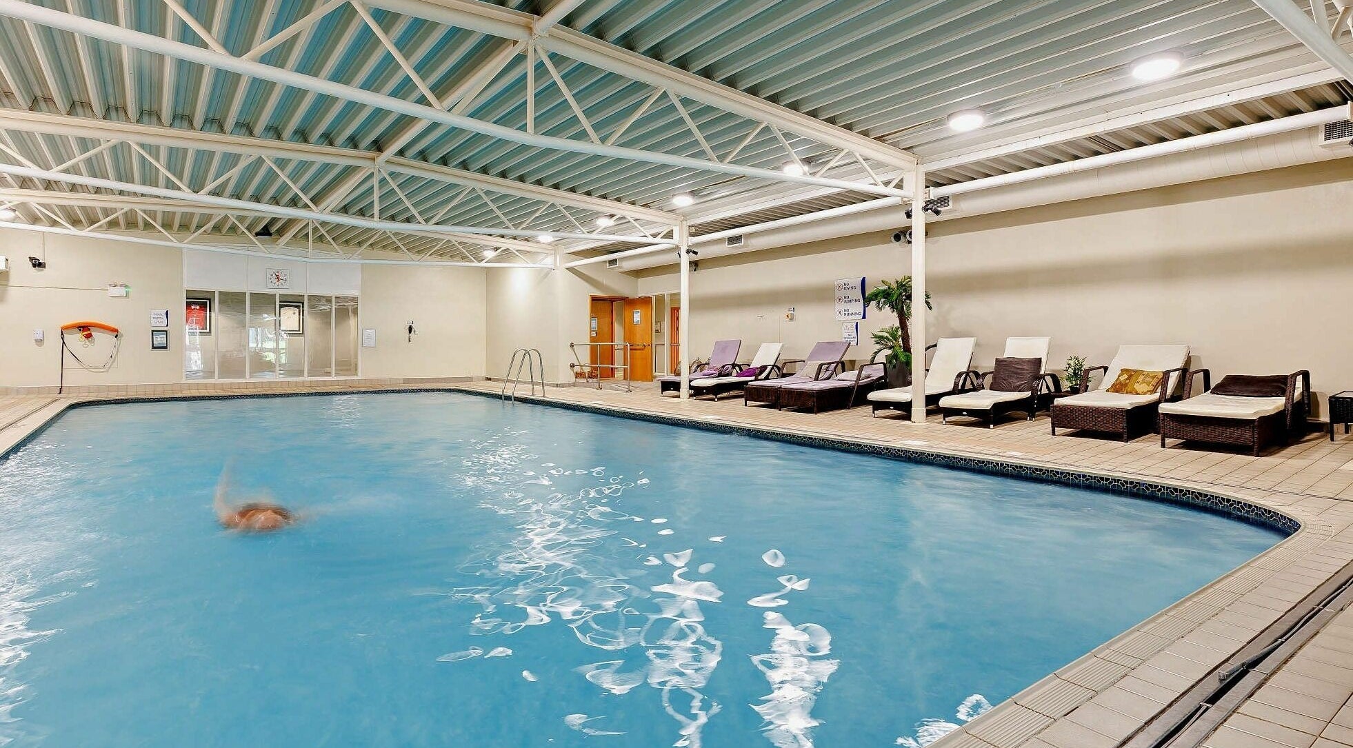 Indoor pool with loungers at Natural Light Spa and Wellness, Guildford, England, GB.