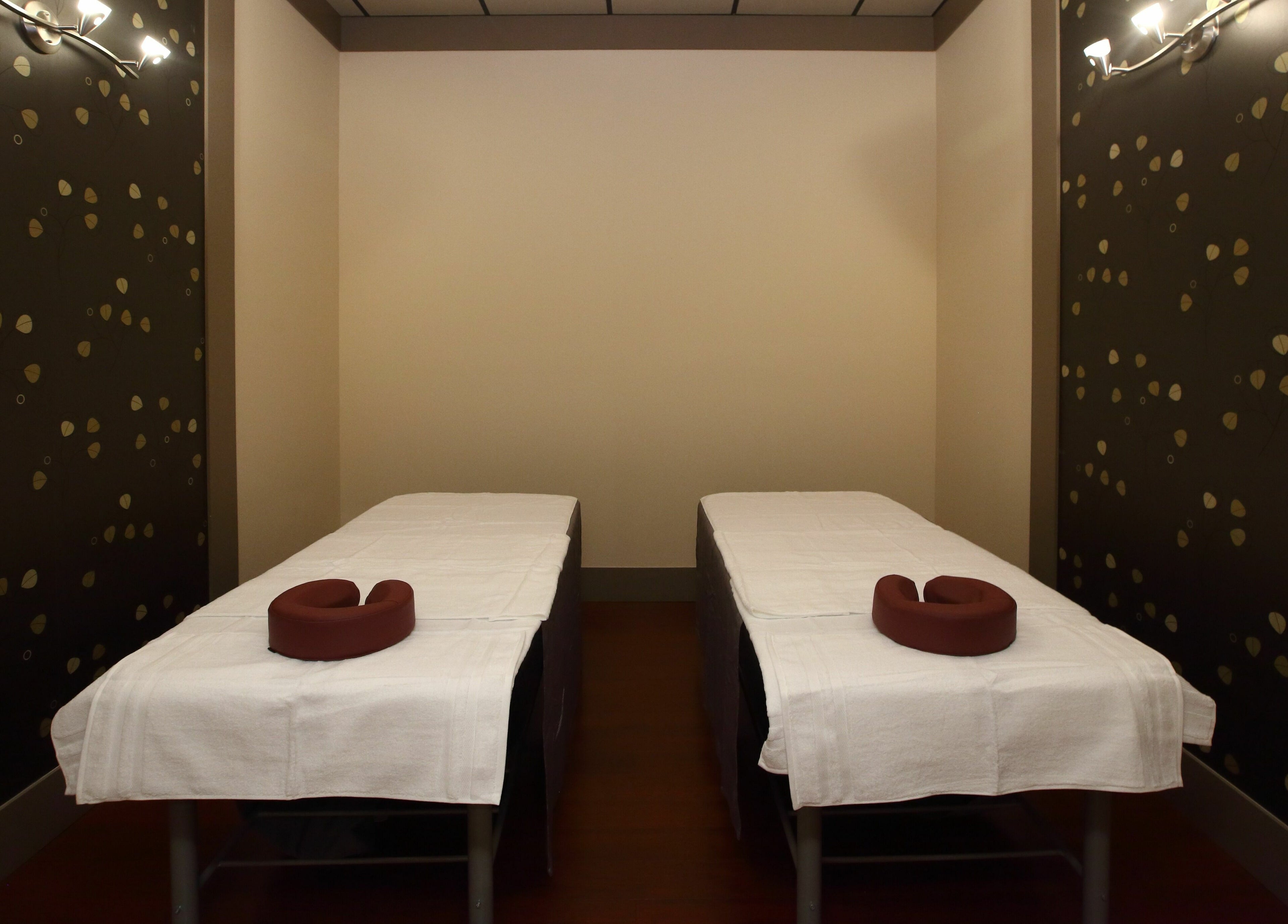 Cozy twin massage tables at Aria Spa, Butler, New Jersey, US offer serene relaxation in stylish ambiance.